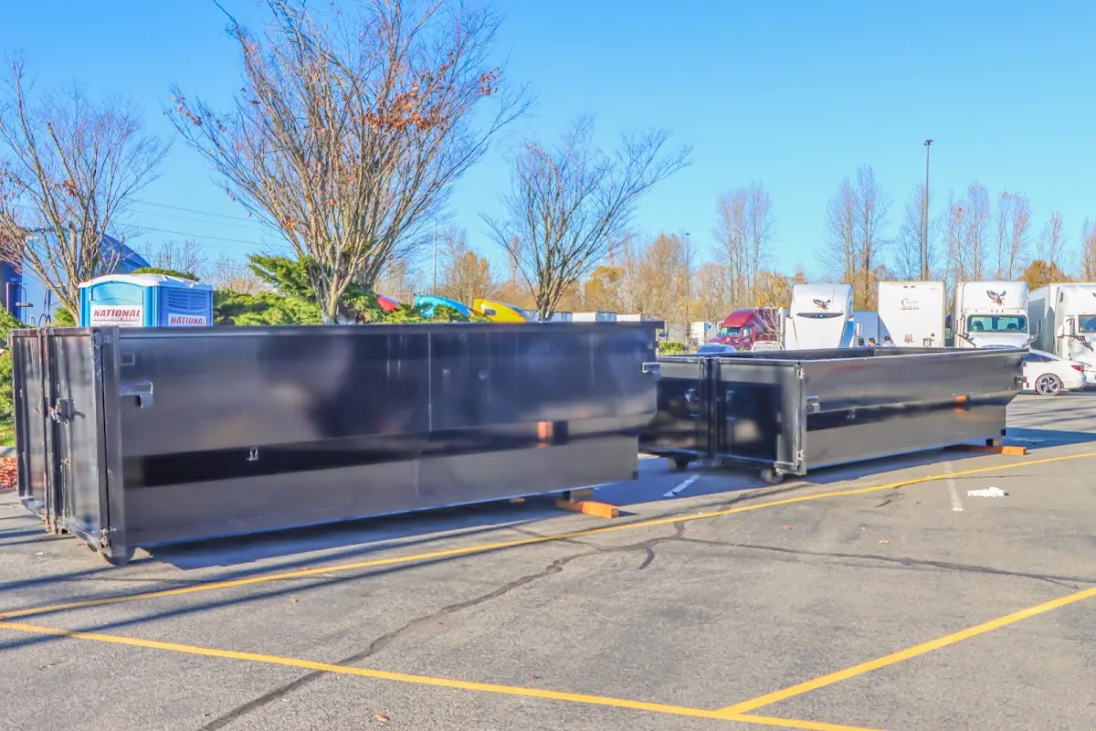 Professional dumpster rental service with roll-off container on residential driveway in Fernandina Beach